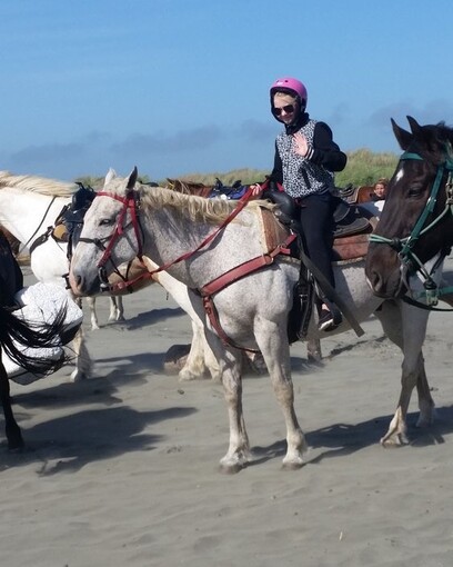 Girl on a horse at Ocean Shores beach